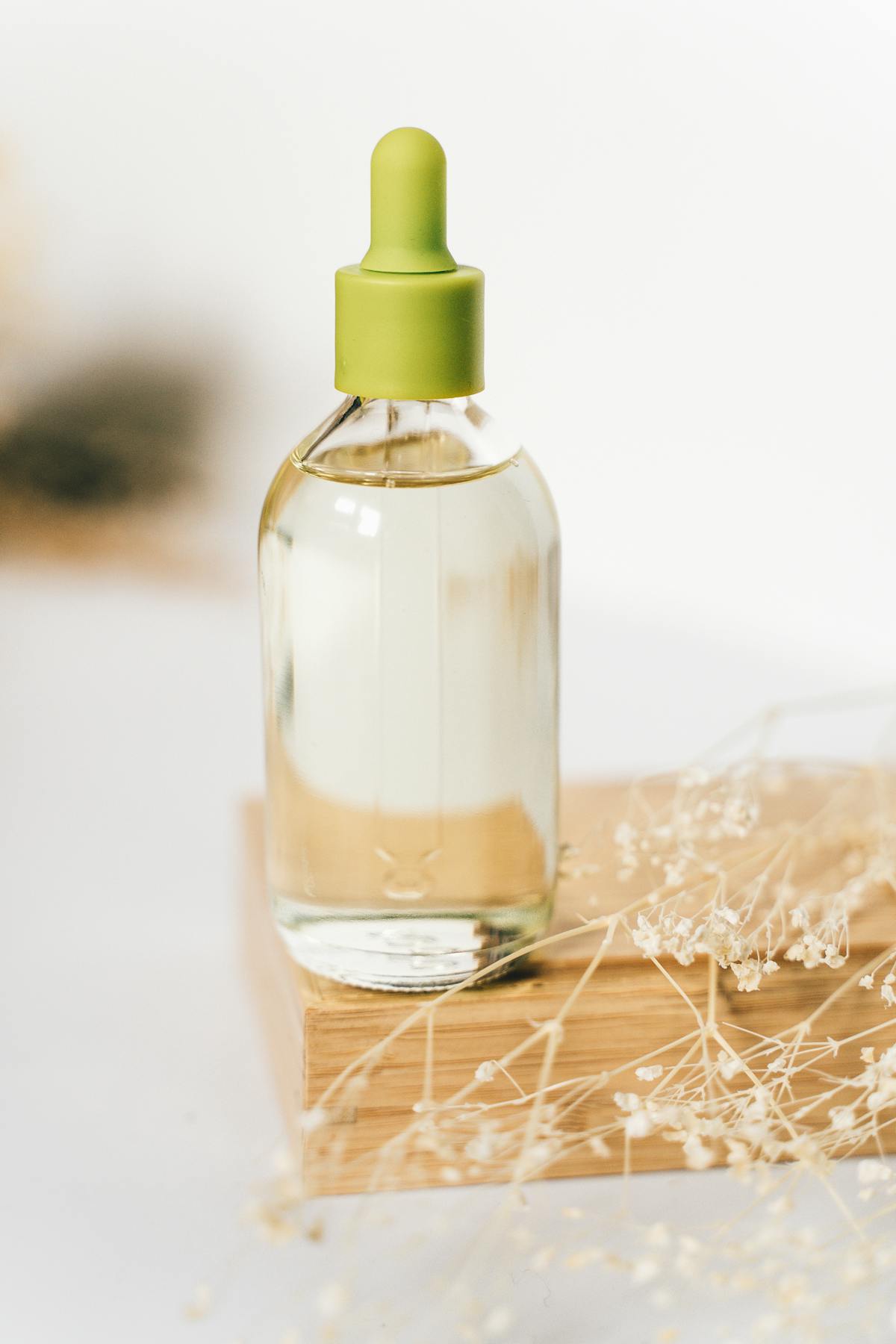 Serum facial en frasco transparente con gotero verde